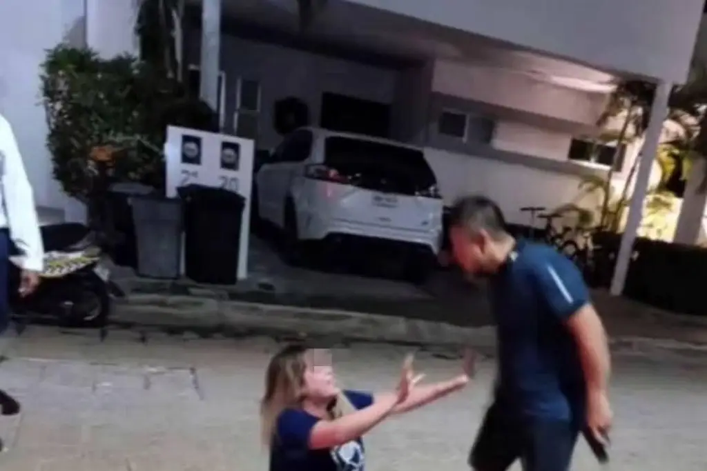 Exhiben a juez que amenaza con arma a su pareja en Cancún